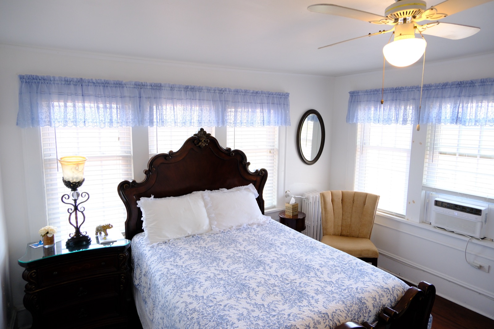 Princess Kate Suite with a carved bed in blue toile linens and a gold accent chair