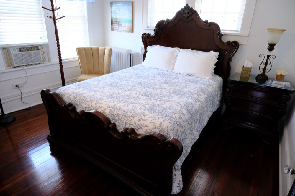 Guest room in blue toile with a coastal painting