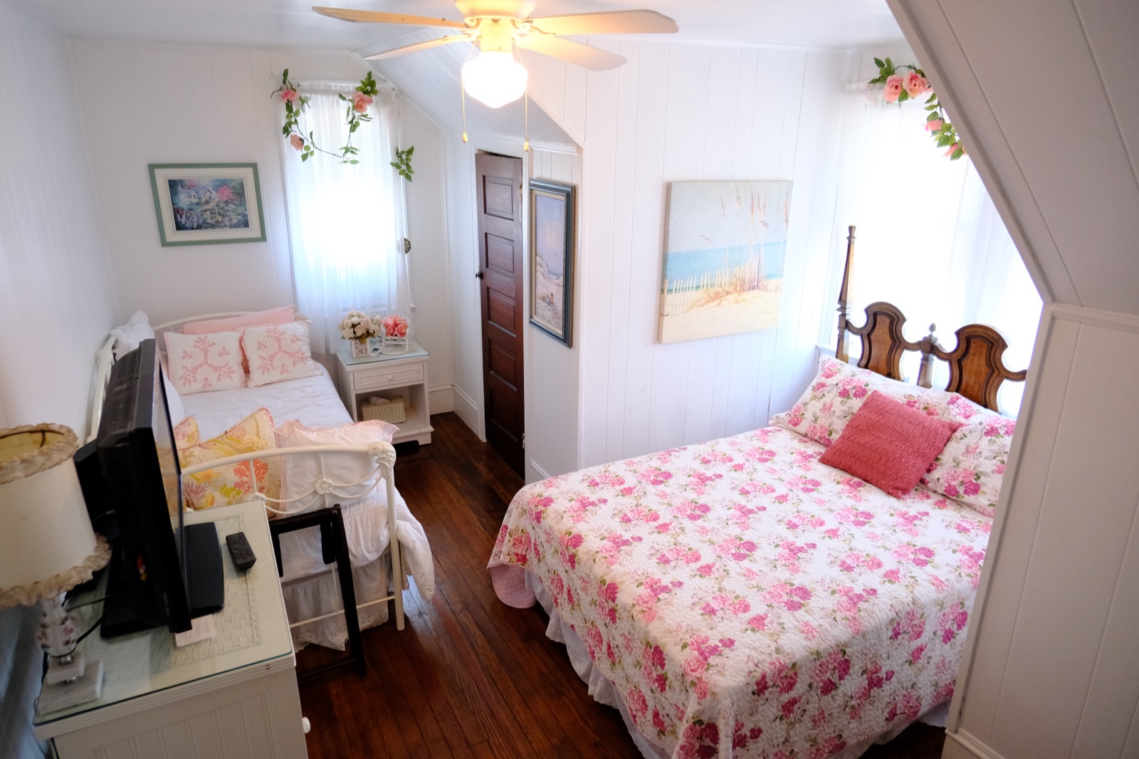 Cambridge Suite dormer room with two beds and coastal artwork on the third floor